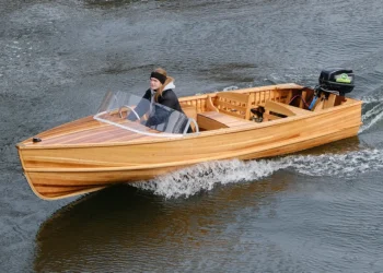 Person rides Giesler boat across calm waters