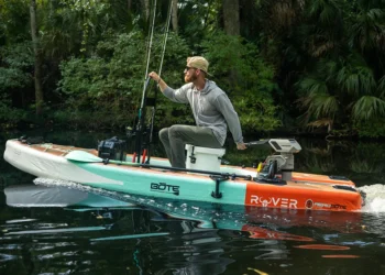 A man using Newport's new NT300 kayaking on a lake
